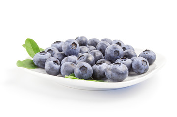 Close-up of fresh blueberries in white bowl on  background