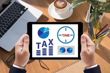 TAX TIME   Business team hands at work with financial reports