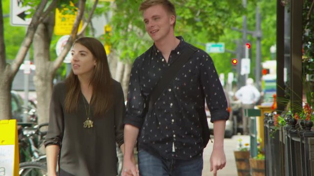 Slow motion young couple walking on the streets