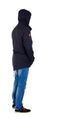 Back view of handsome man in winter jacket looking up. The guy in the stands wearing the hooded jacket left side with his hands in his pockets. © ghoststone
