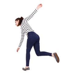 Balancing young woman. or dodge falling woman. Girl in a striped sweater slipped down.