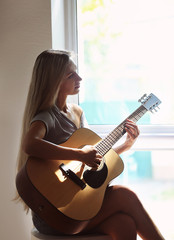 Beautiful woman playing guitar