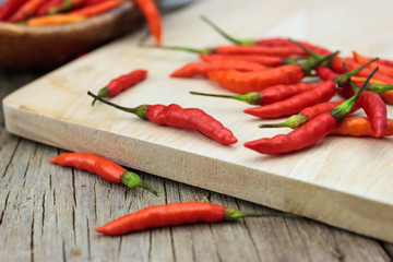 Red chili Peppers on wood chopping background