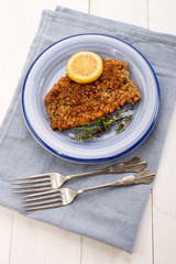 scottish with oatmeal coated kipper with thyme and slice lemon
