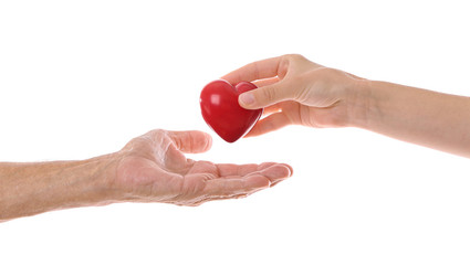 Old male and young female hands with heart figure on white background