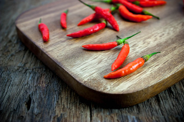 Red chili Peppers on wood chopping background