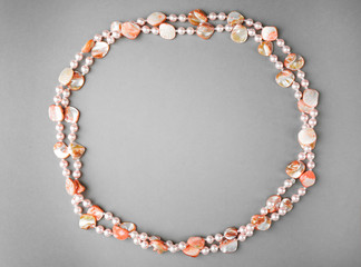 Stylish beads on grey background
