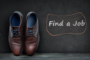 Find a job text on black board and business shoes