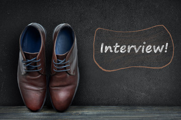 Interview text on black board and business shoes