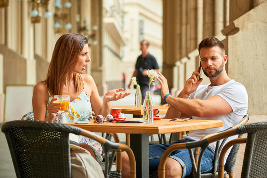 Young tourist couple at a table