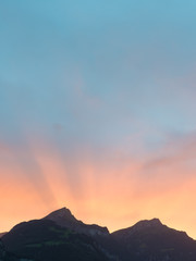 Sun set behind the mountain peaks in the Alps of Switzerland.