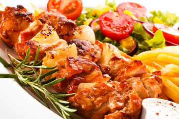 Kebab - grilled meat and vegetables on white background