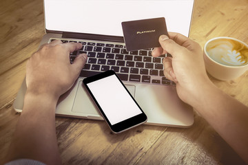 Online payment,Man's hands holding a credit card and using lapto