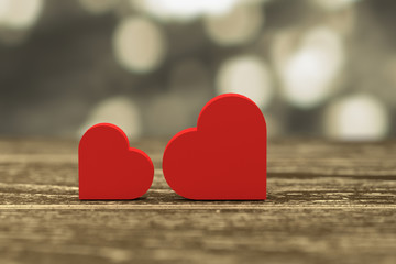 3D rendering - illustration of red heart box put on a wooden table with gold blurred abstract out of focus light,love couple concept