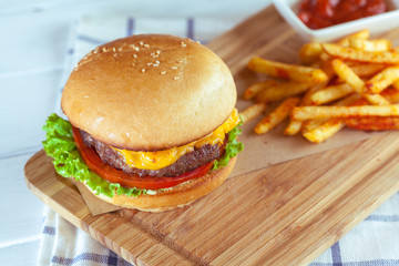 burger and french fries on wooden table
