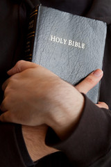 Young man holding Bible
