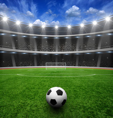 Obraz na płótnie Canvas Soccer ball on green stadium