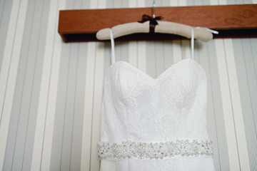 Beautiful white wedding dress for bride indoors. Beauty of bridal gown for marriage. Female lace clothes for celebration