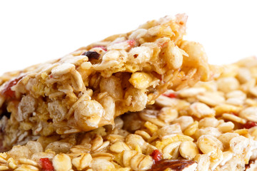 Deatail of one and half muesli bars on white.