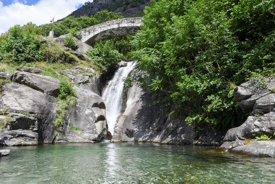 Santa Petronilla waterfalls with roman bridge in Biasca