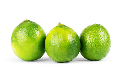 three limes isolated on white background close up