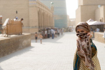 The woman - a Muslim on the street covers his face with a silk handkerchief