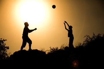 two brothers, boys play at sunset.