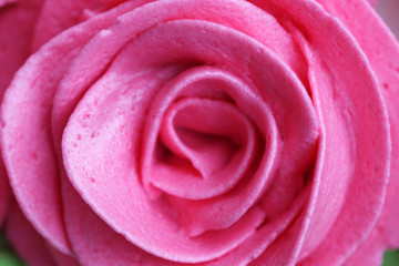 close up of rose whipped cream on cake