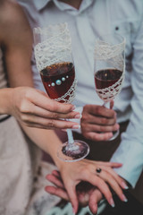 Beautiful Young Couple Having Picnic in Countryside. Happy Family Outdoor. Smiling Man and Woman relaxing and drinking Wine in Park. Relationships