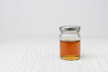 Sweet honey in jar isolated on white wooden