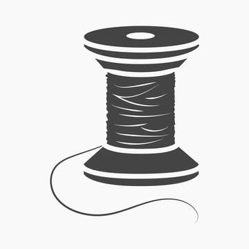 Threaded Needle And Black Spool Of Thread Stock Photo - Download