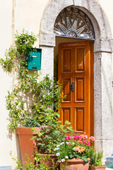 Fototapeta na wymiar Italian house exterior decorated with potted plants