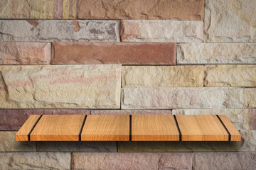 Empty top wooden shelves and stone wall background. For product display