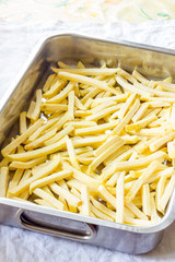 Baking pan of chips to be cooked in the oven