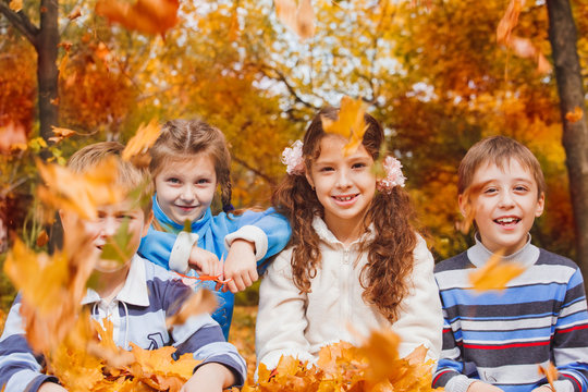 Kids playing with yellow leaves