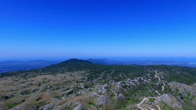 Corfu Greece mountain summit land terrain aerial 4k video panoramic. Hills peak, blue sky