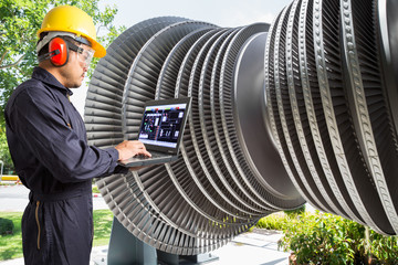 Engineer using laptop computer for maintenance steam turbine 