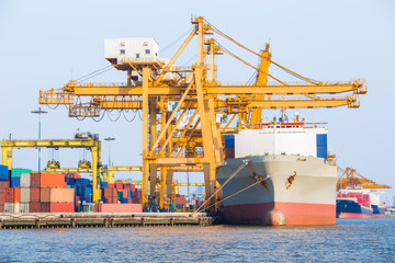 Fototapeta premium Container cargo freight ship with working crane loading bridge 