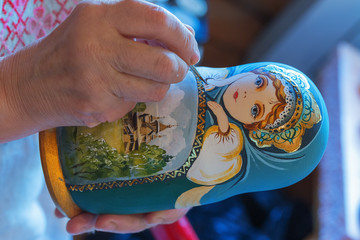 Leningrad region, Podporozhsky District, Russia , June 26, 2016: Painted handmade wooden dolls matreshka - The village of Upper Mandrogi is a reproduction of a traditional Russian village.