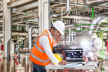 Engineer working at control room of a modern thermal power plant