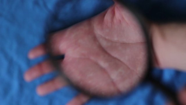 Looking through the magnifying lens on hands