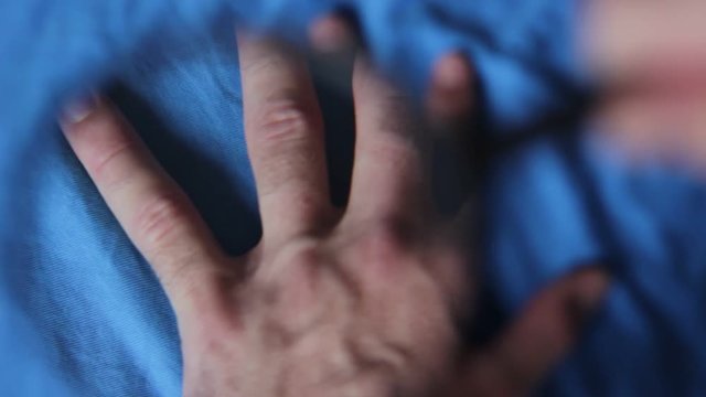 Man's hand through the magnifying lens