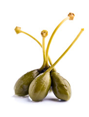 canned capers on white reflective background