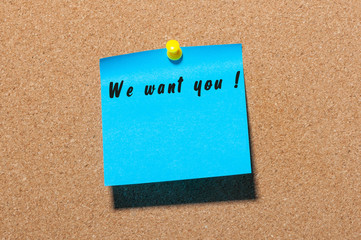 WE WANT YOU message on the sticker pinned at notice cork board. Hiring concept