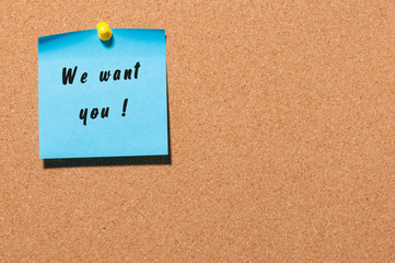 WE WANT YOU message on the sticker pinned at notice cork board. Hiring concept