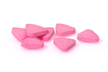 Pink pills triangle shape close up macro photography drug on  white background