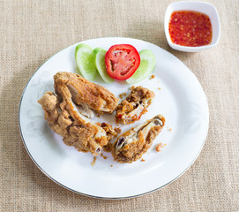 Chicken fried with sauce in white dish on brown cloth / Select f