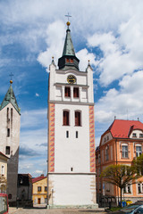 Fototapeta na wymiar White bell tower in the historical centre of Vimperk, Southern Bohemia, Czech Republic