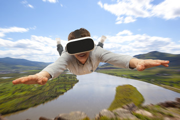 Man wearing virtual reality glasses flies over nature