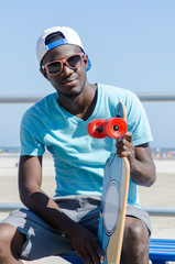 Young man outdoors with his skateboard